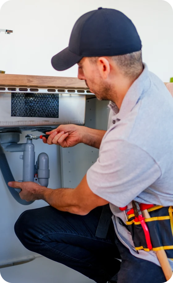 Technician working under sink
