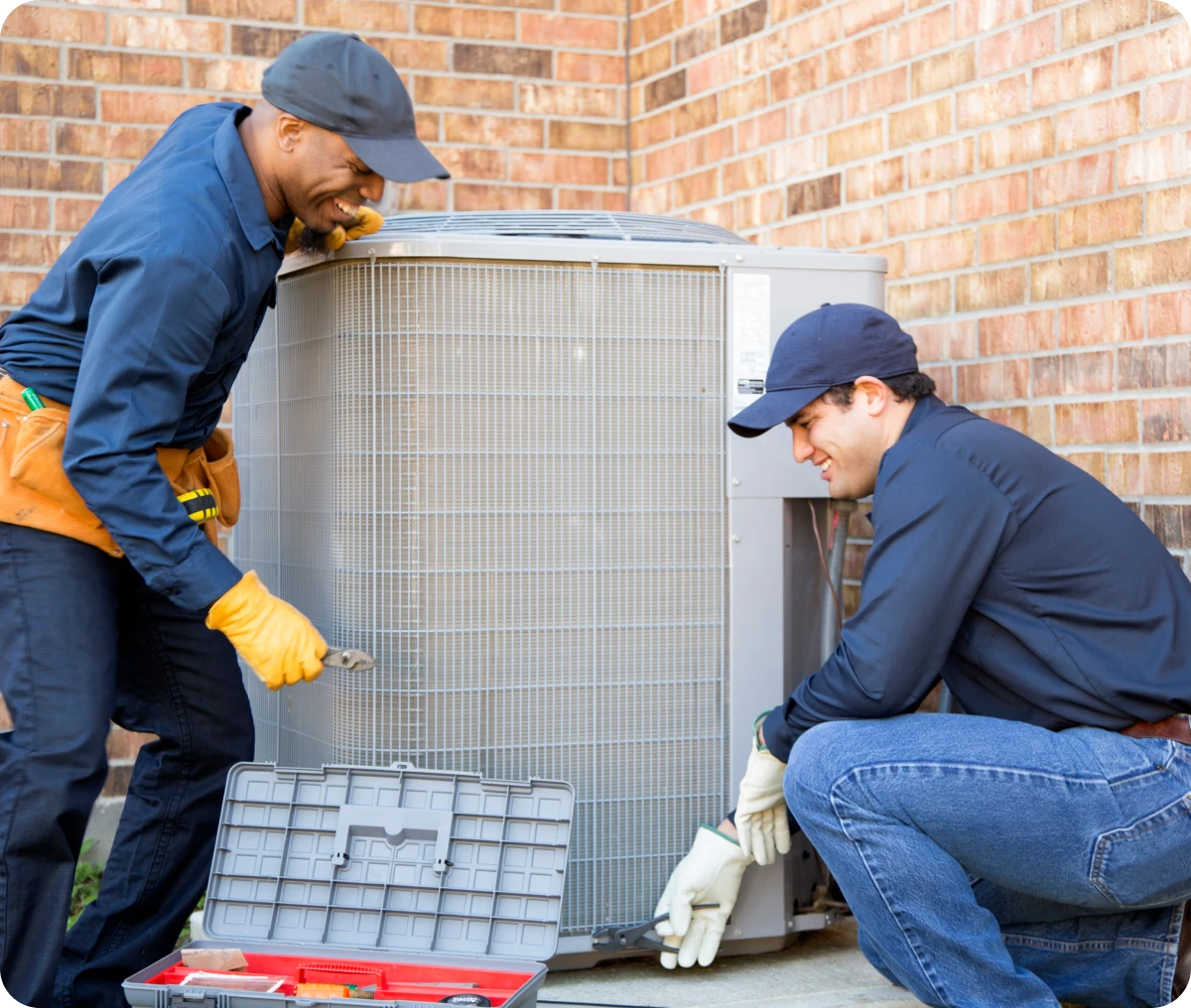HVAC professionals fixing AC unit